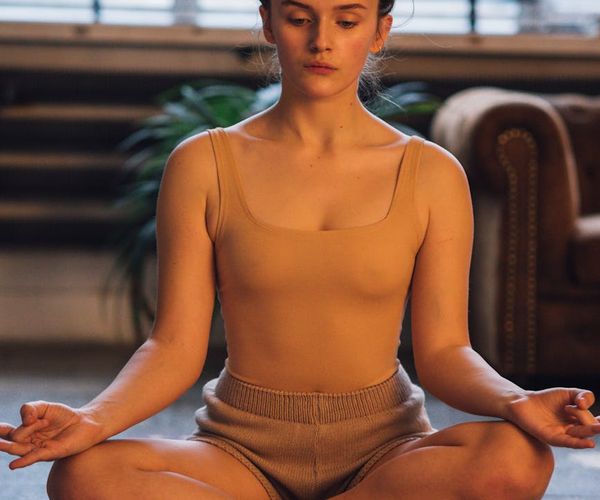 Person in a meditative pose with a feeling of deep well-being.